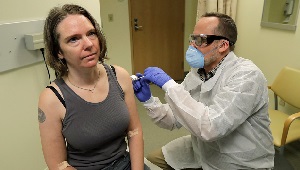 Jennifer Haller, a clinical trial volunteer, receives the first-ever injection of an investigational vaccine for the coronavirus. Credit: Ted S. Warren / AP Photos