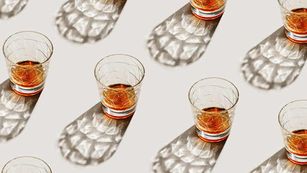 Glasses with alcohol sit on table